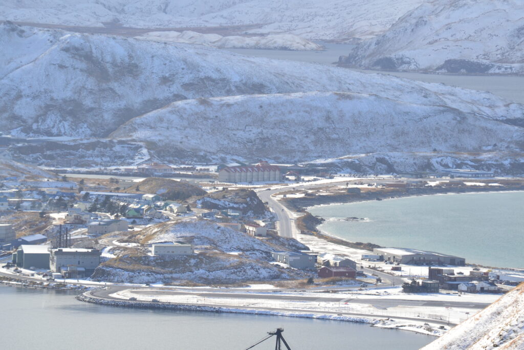 Mountain town of Unalaska covered in snow surrounded by two bays