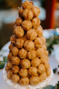 Tower of cream puffs drizzled with caramel