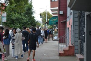 People lining up to get into a bakery