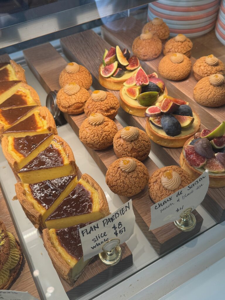 French tarts in a display case with some chouxs, flans, and fig tarts