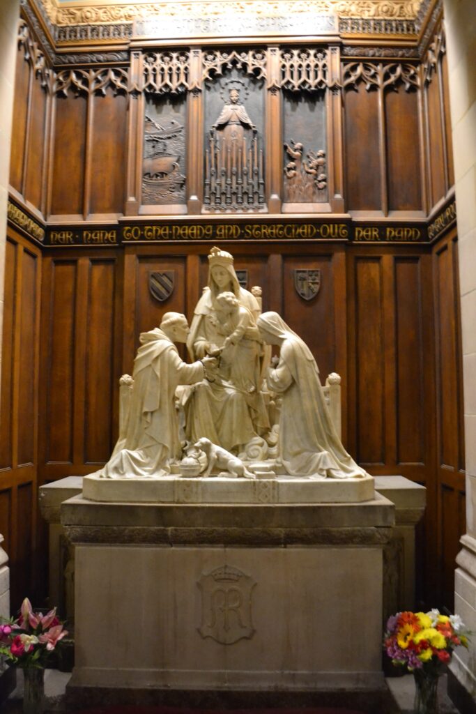 Statue of Mary with Jesus on her lap and two Saints by her side