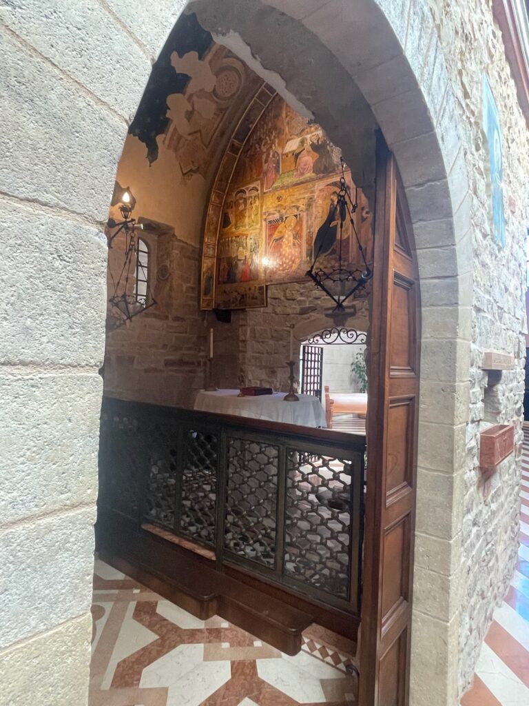 View of a Catholic altar through an arched doorway