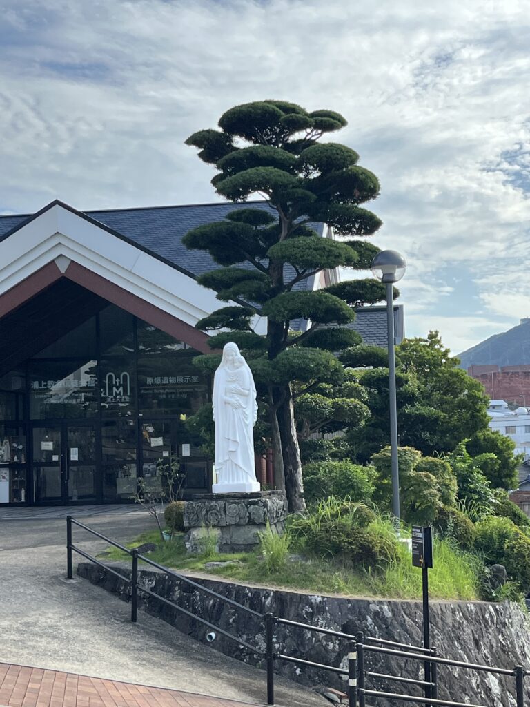 A statue of Mary in front of the Congregational Hall of Urakami cathedral