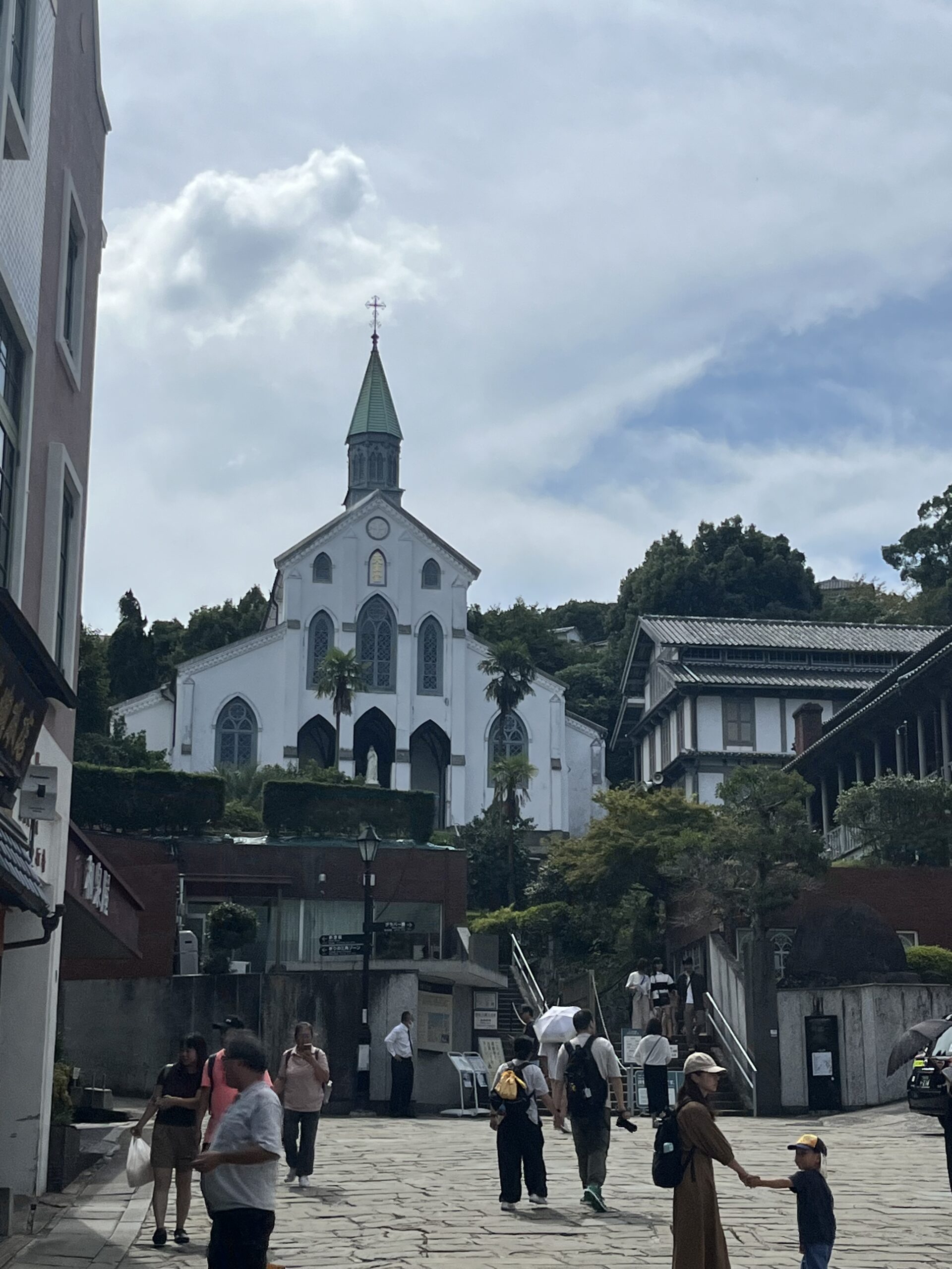 Catholic church in the distance at the top of the hill with a street leading up to it