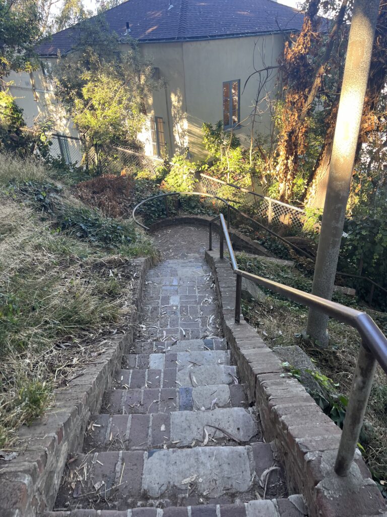 Stone stairs lead down and take a right turn