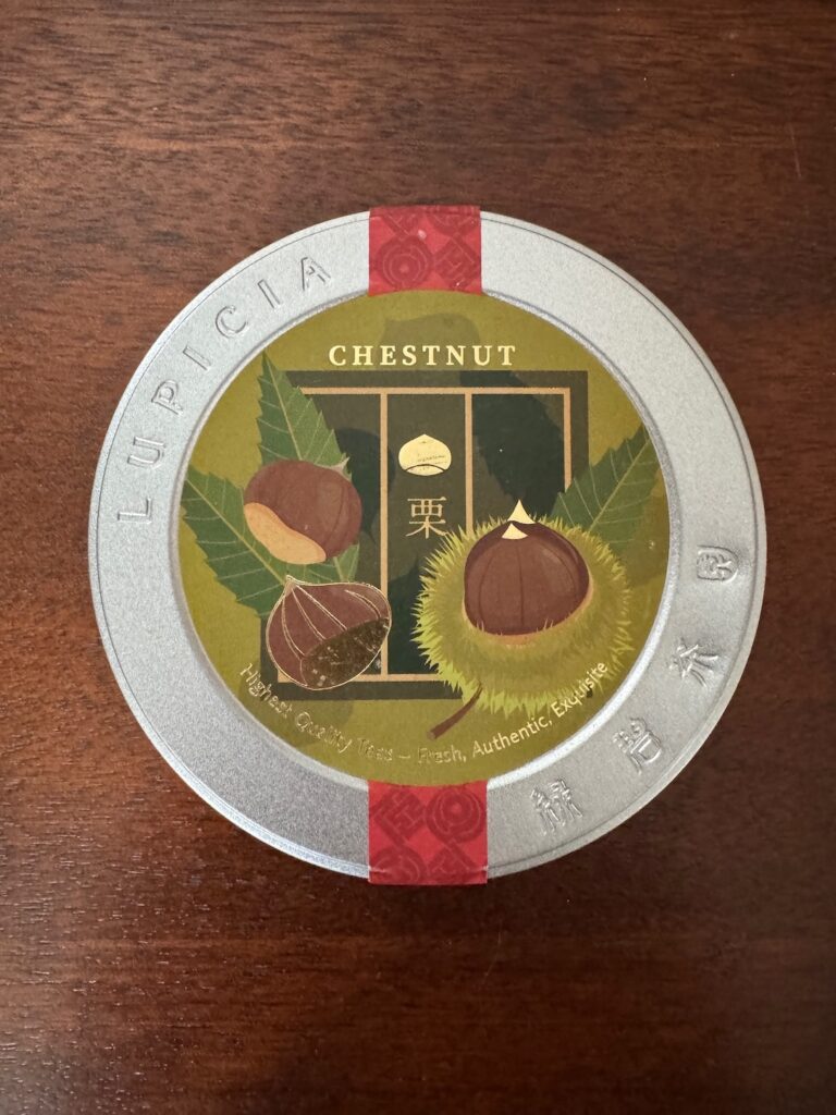 A tin container with a green label on it that has "chestnut" written across the top with pictures of chestnuts under it