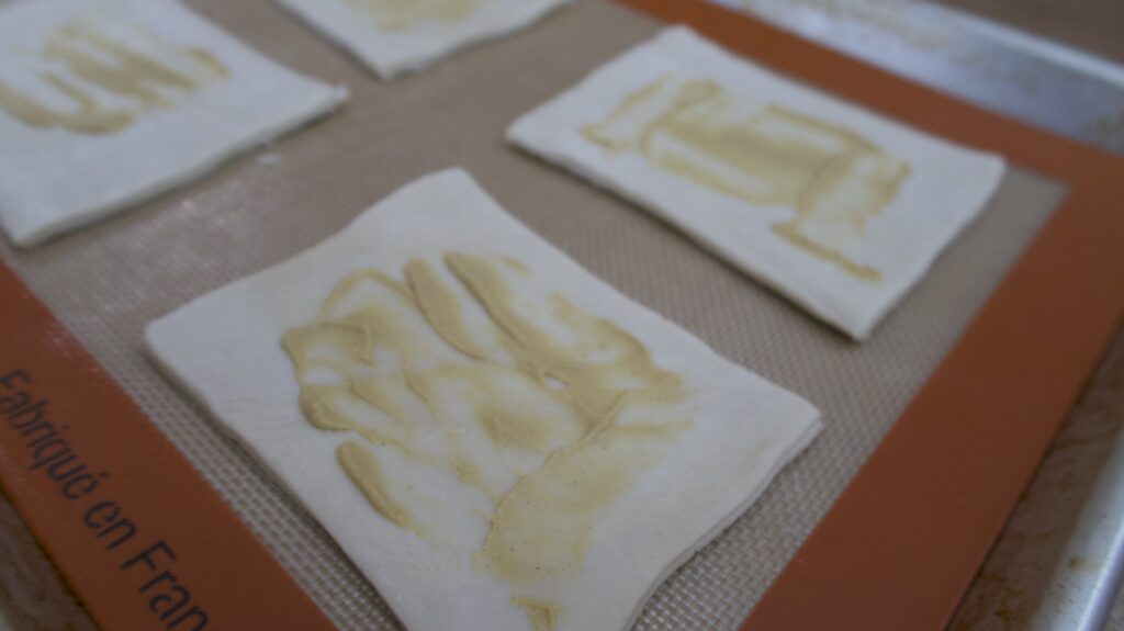 Puff pastry sheet with dijon mustard spread on top