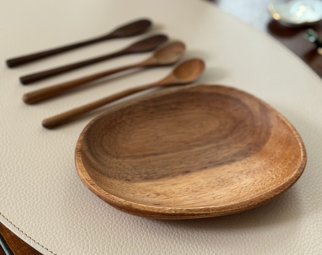 Wooden plate and four wooden spoons lay on display