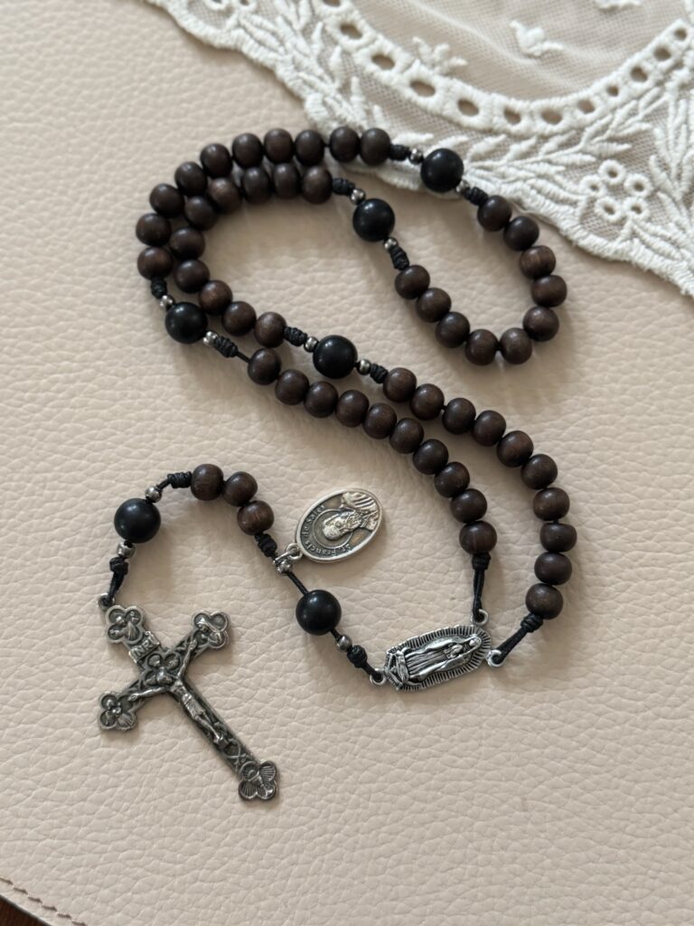 Rosary displayed next to a lace fabric