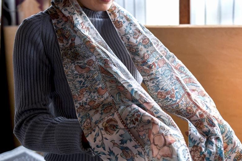 Person wearing a handmade patterned scarf, traditional Japanese textile craft and scarf-making experience