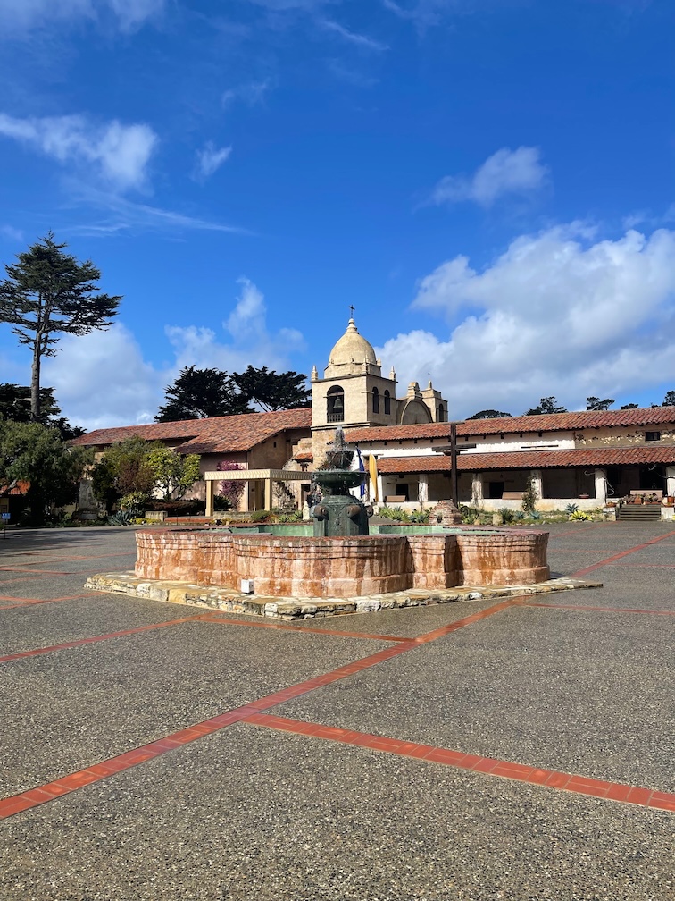 Spanish fountain in the foreground with Carmel Mission Basilica in the background