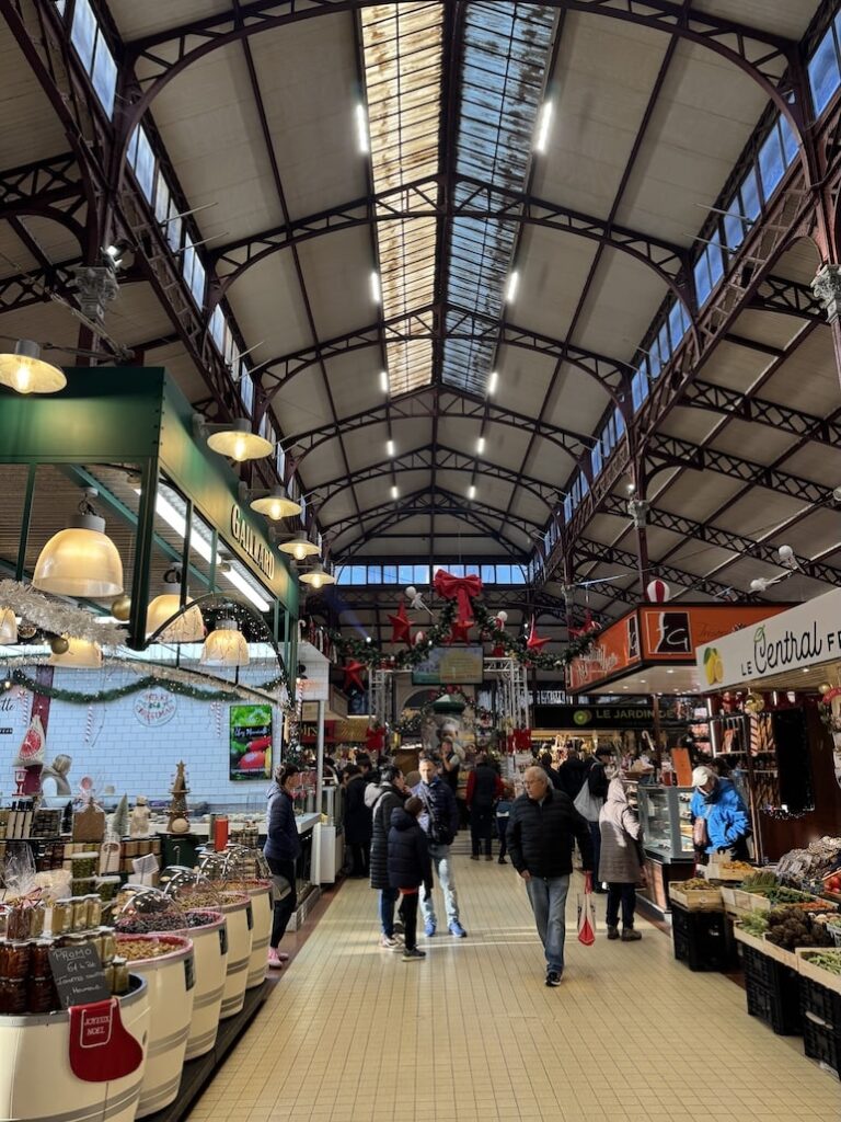 Indoor French market with food stalls decorated for Christmas season