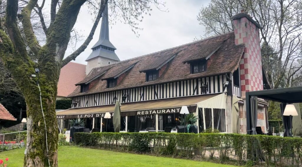 Exterior of a Normandy style restaurant with a spire