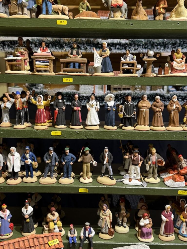 Close-up of handmade terracotta figurines sold at French Christmas markets