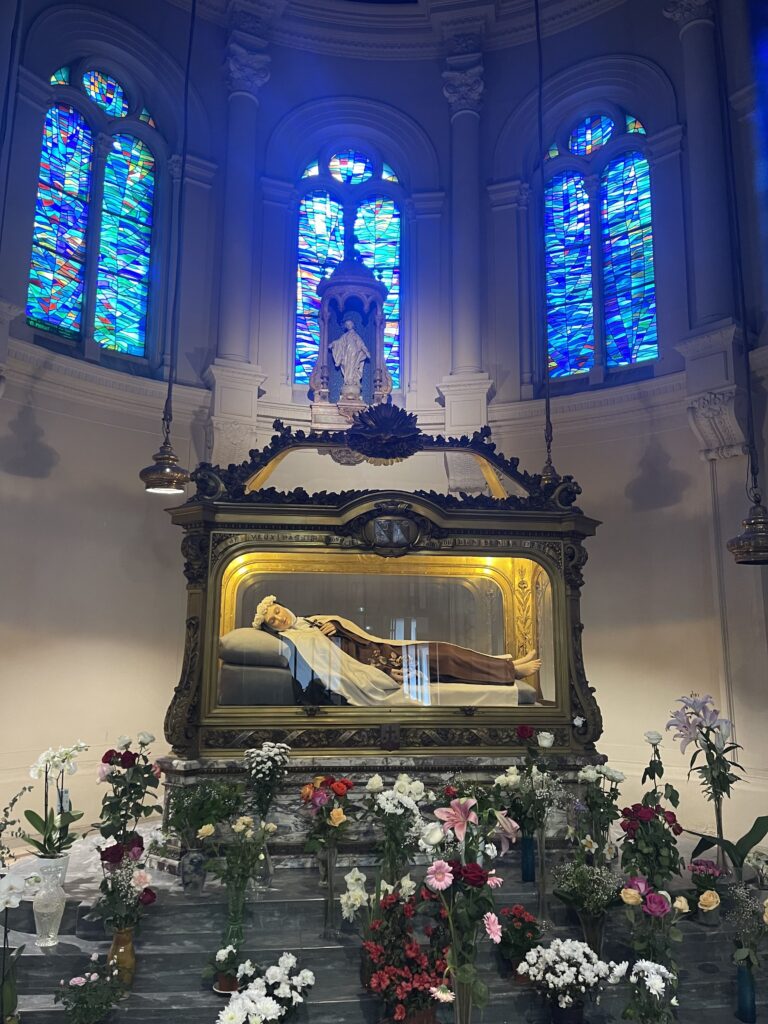 Shrine of St. Therese of Lisieux with glass tomb and statue of her on top of the tomb