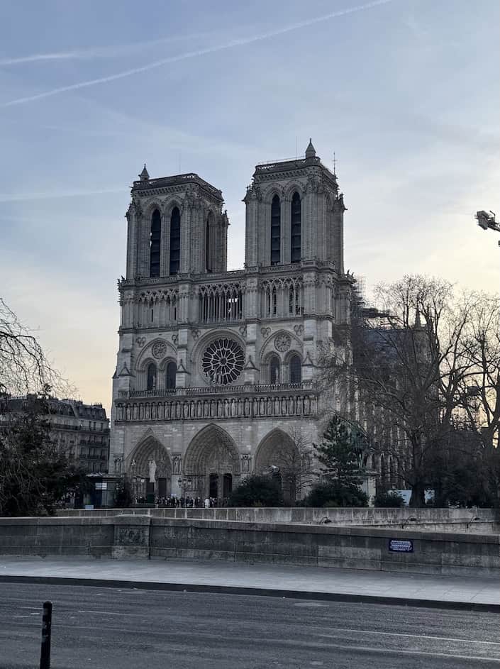 Front of the majestic Notre-Dame with a line forming in front to enter the newly restored Cathedral