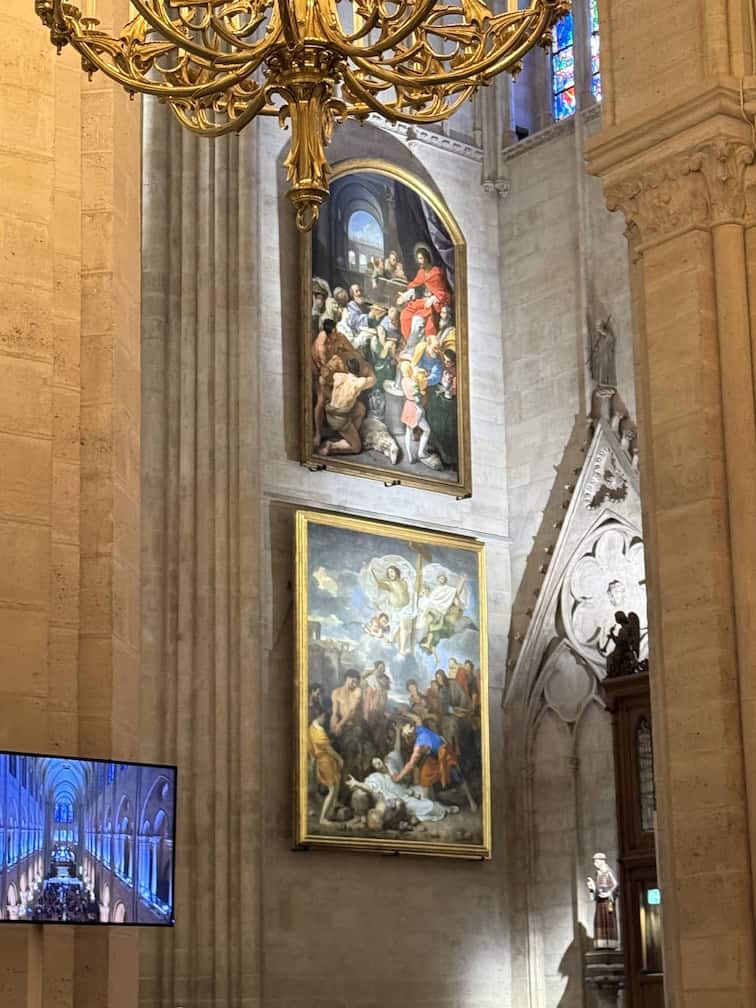 Two large Catholic art hung one on top of the other in Notre Dame Cathedral after restoration from the fire