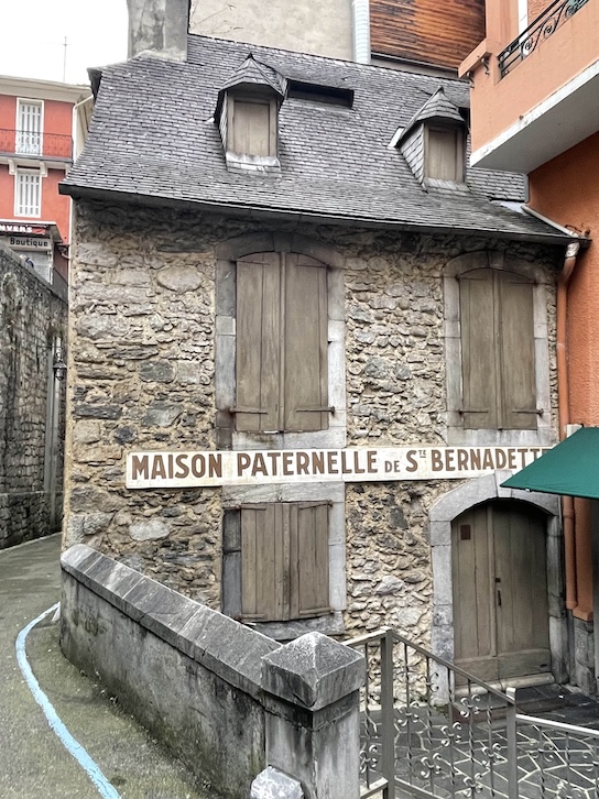 A stone house in Lourdes, France belonging to the Soubirous family after the apparitions it is two stories with wooden shutters and an attic with windows too