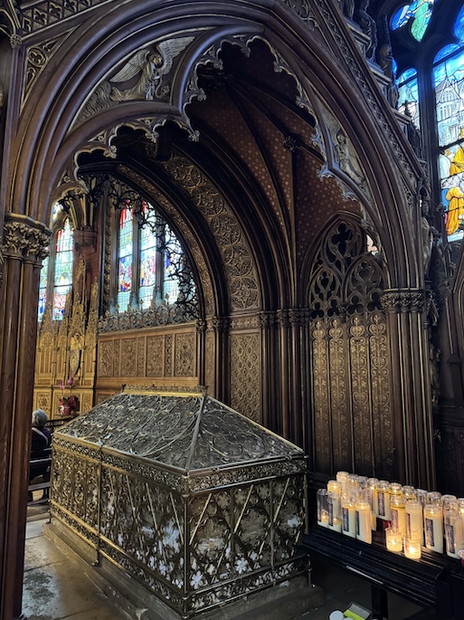 The shrine of St Genevieve inside St. Etienne Du Mont Church, an ornate coffin-like reliquary under wooden stunning arches