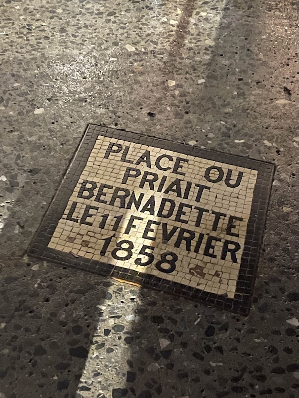 Mosaic in the ground marking the spot where St. Bernadette prayed on 11 February 1858, the first day of Mary's apparition