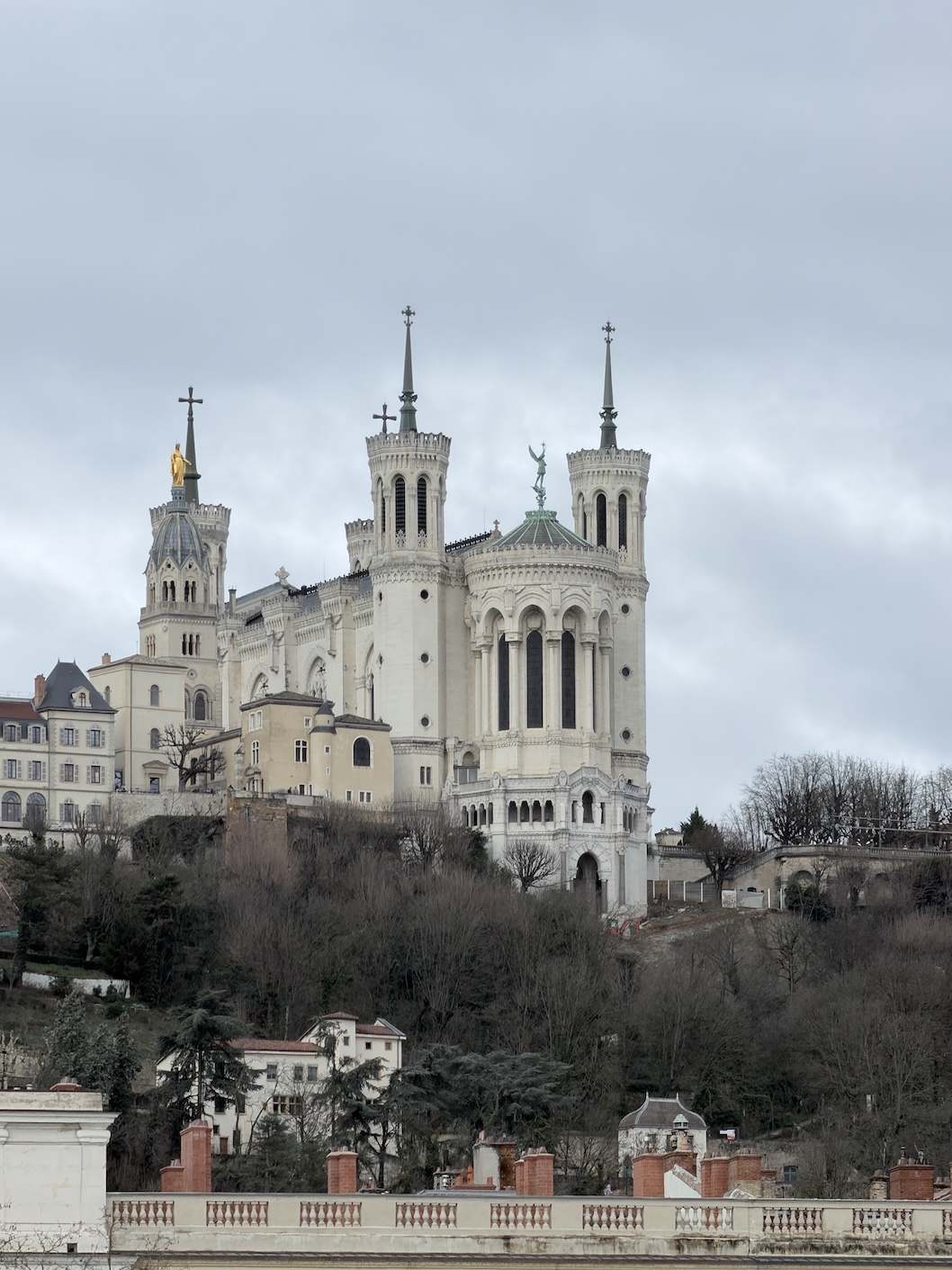 Exterior view of the Basilica of Notre-Dame de Fourvière overlooking Lyon, a famous hilltop church and landmark in France.