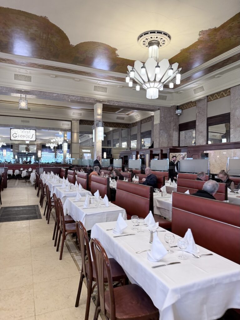Elegant Art Deco dining room at Brasserie Georges Lyon with white tablecloths and classic French brasserie seating