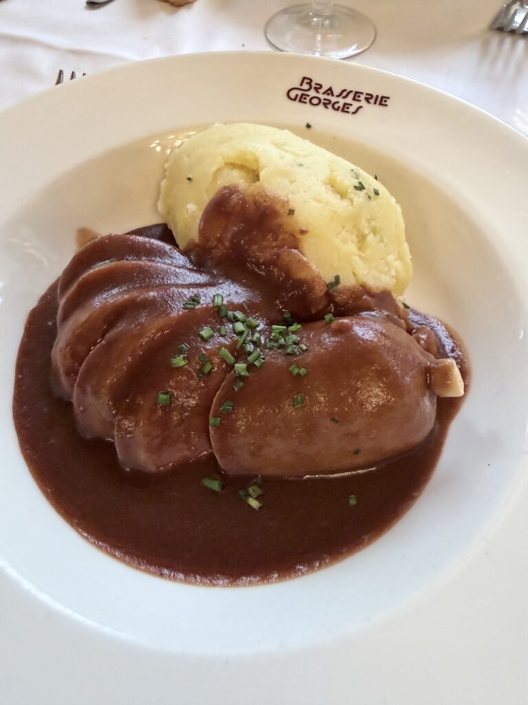 Lyonnaise saucisson sausage with mashed potatoes and red wine sauce at Brasserie Georges Lyon France