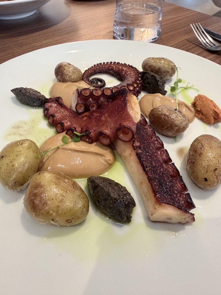 Fine dining octopus with potatoes and sauce served at Epona restaurant InterContinental Lyon France