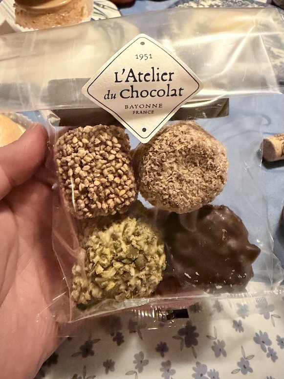 Artisan chocolate truffles assortment from L’Atelier du Chocolat Bayonne France featuring coated praline and dark chocolate sweets in Lyon France