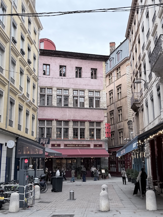 Charming pedestrian street in central Lyon France with classic architecture and local cafés