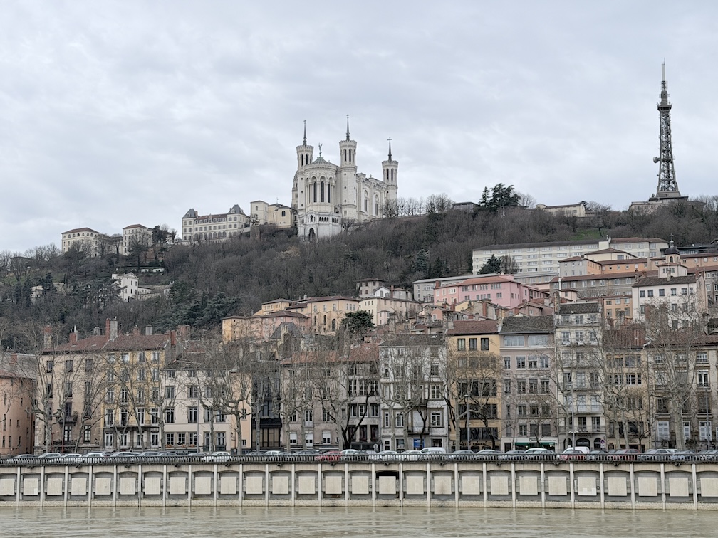 View of Fourvière hill with Basilica of Notre-Dame de Fourvière and Lyon skyline along the Saône River.