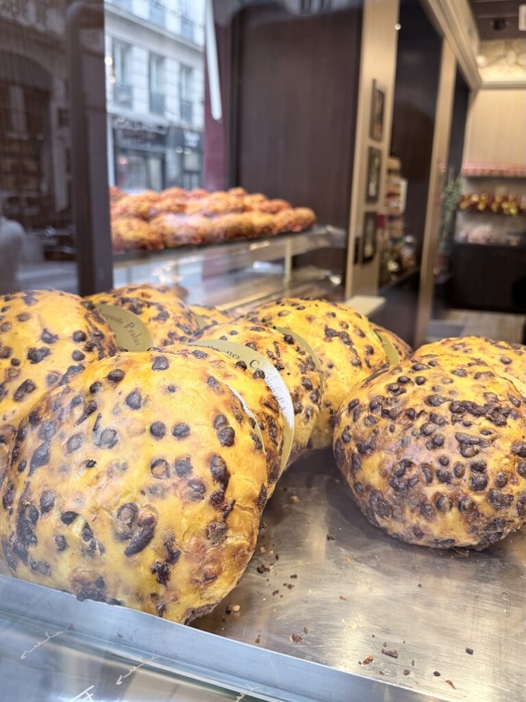 Fresh chocolate chip brioche loaves displayed at Pralus bakery Lyon famous French pastry shop