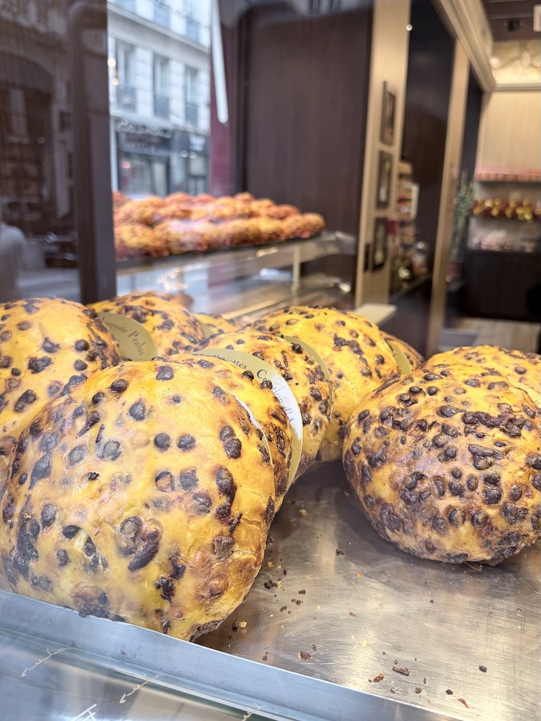 Fresh chocolate chip brioche loaves displayed at Pralus bakery Lyon famous French pastry shop