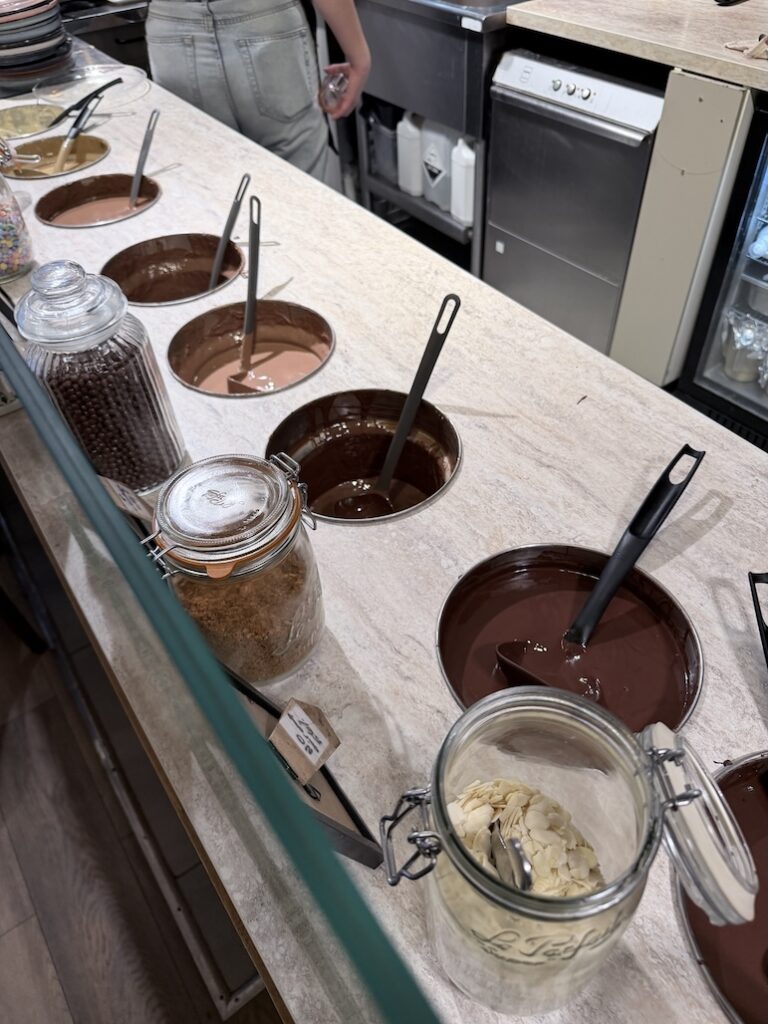 Multiple melted chocolate varieties at Ikône chocolate fondue bar in Lyon France dessert experience