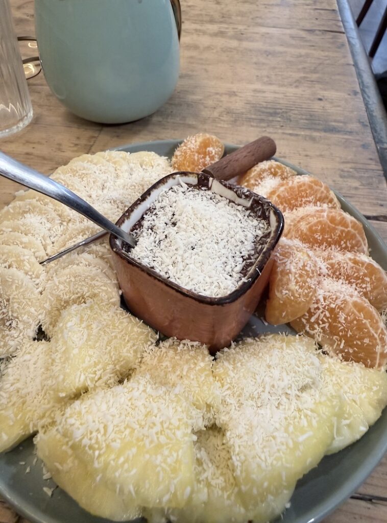 Chocolate fondue with fresh pineapple citrus and coconut at Ikône dessert café Lyon France
